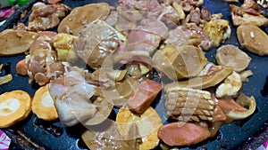 Heat various pieces of processed meat in a grill pan