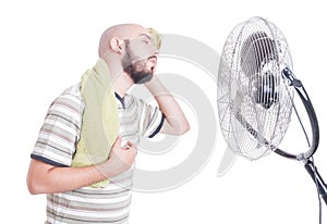 Heated man wiping sweat in front of cooler