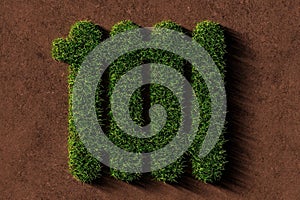 Heater symbol made from green grass on brown soil background, green heating or energy concept