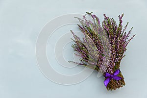 Heather flowers bouquet on gray wooden background. Top view. Copy space