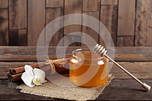 Heather honey and cinnamon on wooden table