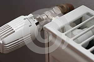 Heating controler on a white radiator.