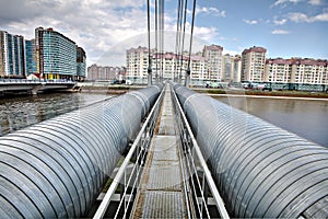 Heating duct crosses river on cable-stayed bridge in residential