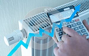 heating and energy costs rise. spend more money on heating. Expensive heating costs. hands with calculator consider cost of