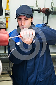 Heating engineer in boiler room