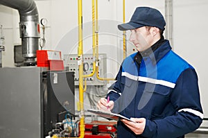 Heating engineer in boiler room