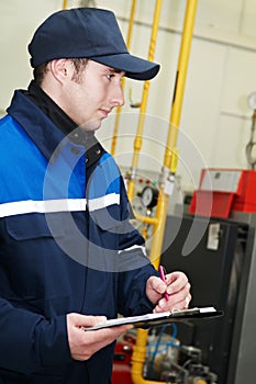 Heating engineer in boiler room