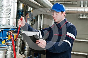 Heating engineer in boiler room