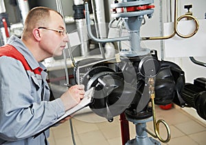 Heating engineer in boiler room