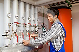 Heating engineer in a boiler room for heating