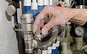 Heating engineer fixing modern heating system in boiler room.