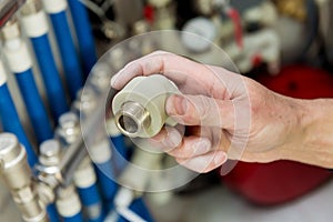 Heating engineer fixing modern heating system in boiler room.