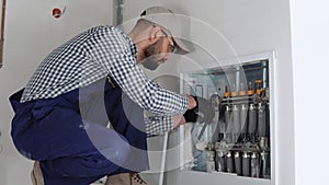 Heating engineer installing modern heating system in boiler room