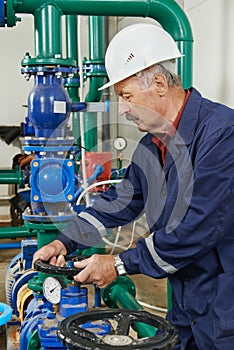 Heating engineer repairman in boiler room