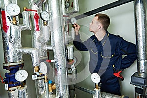 Heating engineer repairman in boiler room