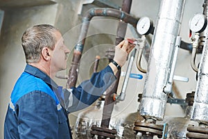 Heating engineer repairman in boiler room