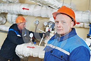 Heating engineer repairmans in boiler room