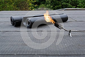 Heating and melting bitumen roofing felt Flat roof installation photo