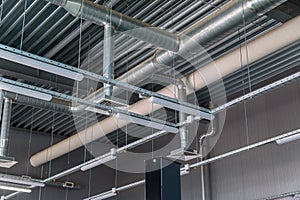 Heating pipe system in the warehouse of the enterprise. ceiling blower system. lighting lamps