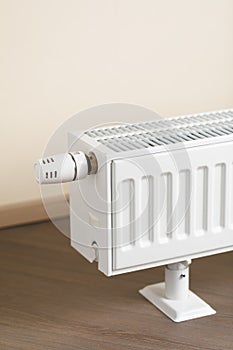 Heating radiator with thermostatic knob in the living room photo