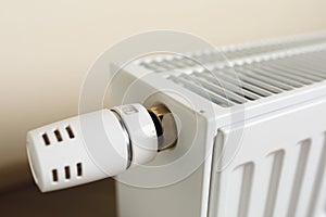 Heating radiator with thermostatic knob in the living room photo