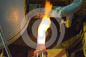 Heating a steel pipe with a blowtorch. The flame of a blowtorch