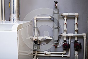 Heating system of a private house, boiler room with gas equipment, water pipes. Dispensing vessel container.