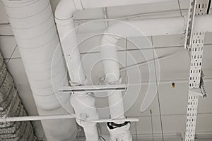 Heating white pipes on the ceiling. Indoor heating