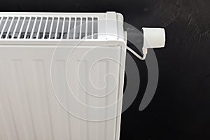 Heating white radiator with adjuster of warming in living room.