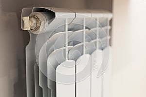 Heating white radiator with adjuster of warming in living room