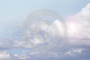 Heaven background. clouds background.White clouds and sun rays in a light blue sky. The sky in light pastel colors