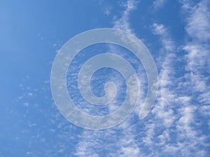 Heavenly background. Peaceful blue sky with white feathery clouds