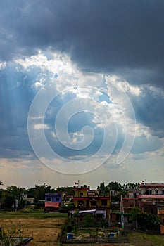 Heavenly Sun Rays Through Dark Clouds Against The Blue Sky.