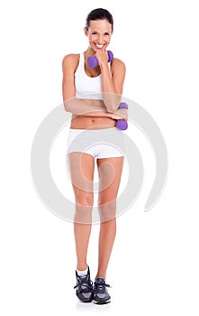 Heavier than they look. Studio shot of an attractive young woman lifting dumbbells  on white.