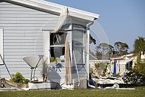 Heavily damaged by hurricane houses in Florida mobile home residential area. Consequences of natural disaster