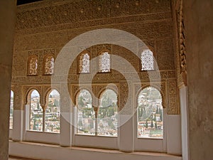 Heavily decorated wall with horseshoe windows of NAsrid Palace , Alhambra, Spain