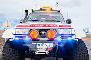 Heavily modified search and rescue Toyota Landcruiser 4x4 truck closing the road