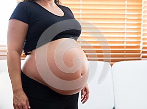 A heavily pregnant woman.