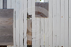 Heavily repaired wooden fence photo