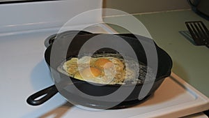 Heavily seasoned eggs frying in pan