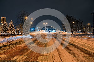 Heavily snow-covered road and sidewalk in an industrial town in Silesia, Poland, JastrzÄ™bie-Zdroj at night