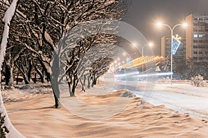 Heavily snow-covered road and sidewalk in an industrial town in Silesia, Poland, JastrzÄ™bie-Zdroj at night