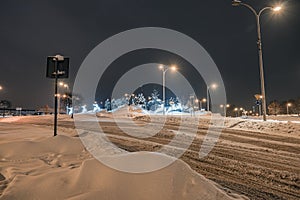 Heavily snow-covered road and sidewalk in an industrial town in Silesia, Poland, JastrzÄ™bie-Zdroj at night