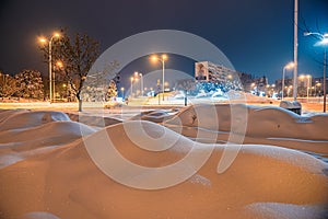 Heavily snow-covered road and sidewalk in an industrial town in Silesia, Poland, JastrzÄ™bie-Zdroj at night