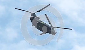 Heavy airlift military helicopter in flight. Double rotor, heavy airlift, military helicopter in flight with rear ramp door open.