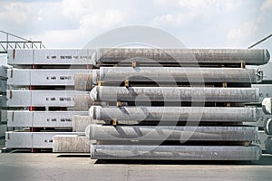 Heavy aluminum bars stacked on top of each other in an aluminum smelting plant, located in the square.