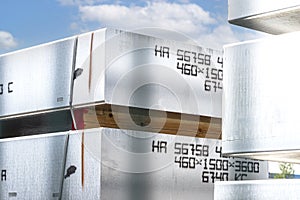 Heavy aluminum bars stacked on top of each other in an aluminum smelting plant, located in the square.