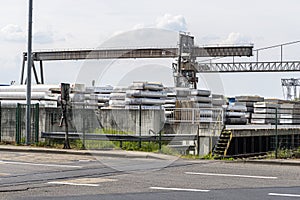 Heavy aluminum bars stacked on top of each other in an aluminum smelting plant, located in the square.