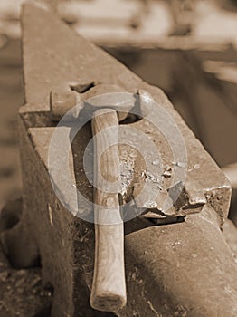 Heavy anvil and sturdy hammer in the blacksmith's shop