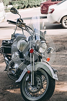 Heavy beautiful motorcycle stands on the street. Chopper or cruiser motorbike parked at the edge of the road without a driver